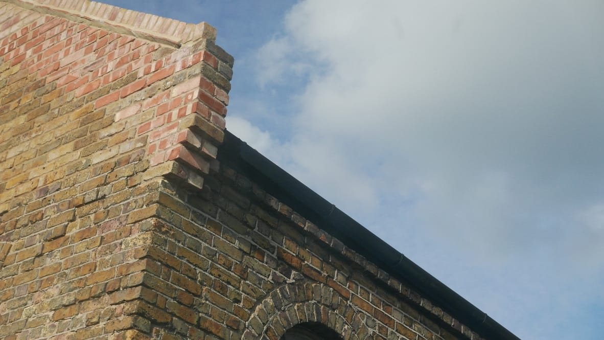 Industrial studio space with large floor-to-ceiling windows providing abundant natural light for professional video production and showreel recording