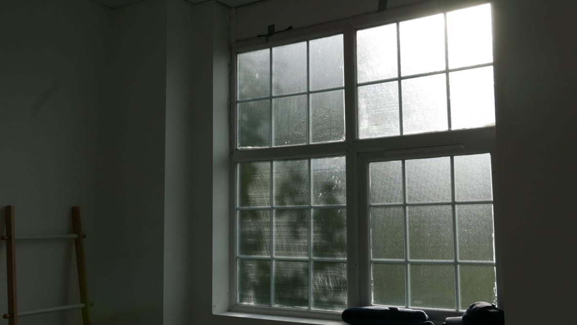 Studio interior with natural daylight streaming through architectural features, showcasing the professional photography environment at Good Mews Studio
